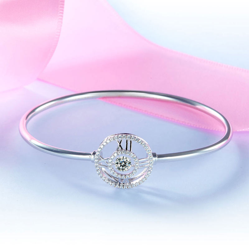 Pulsera brazalete con piedra danzante y reloj con números romanos