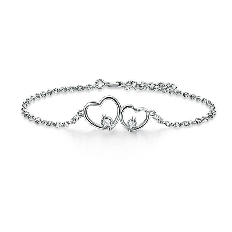 Pulsera de doble corazón con circonitas cúbicas en plata de ley