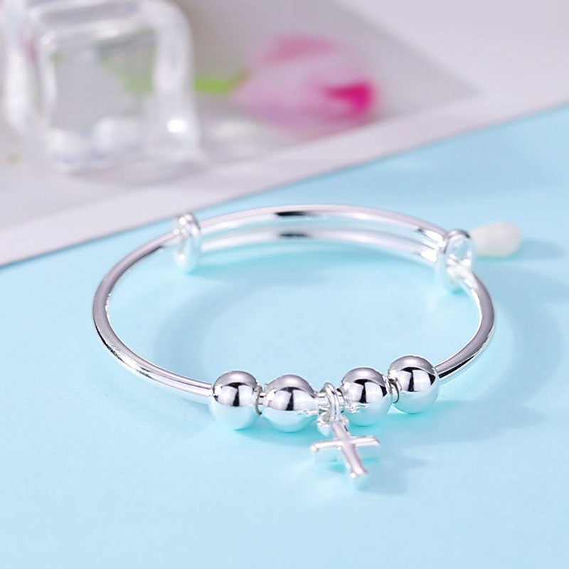 Pulsera ajustable con cruz en plata de ley para niñas