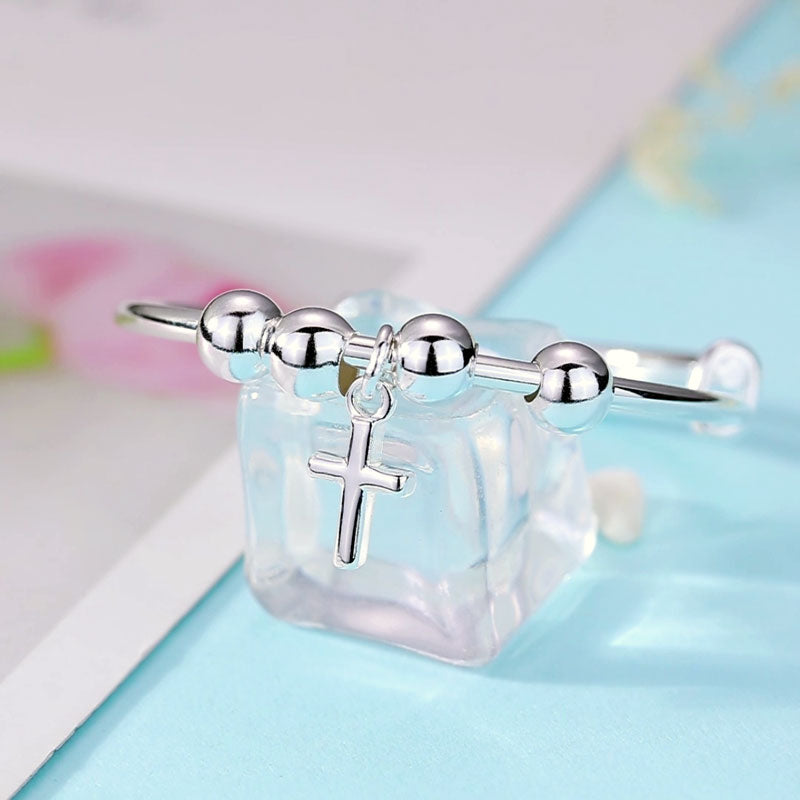 Pulsera ajustable con cruz en plata de ley para niñas