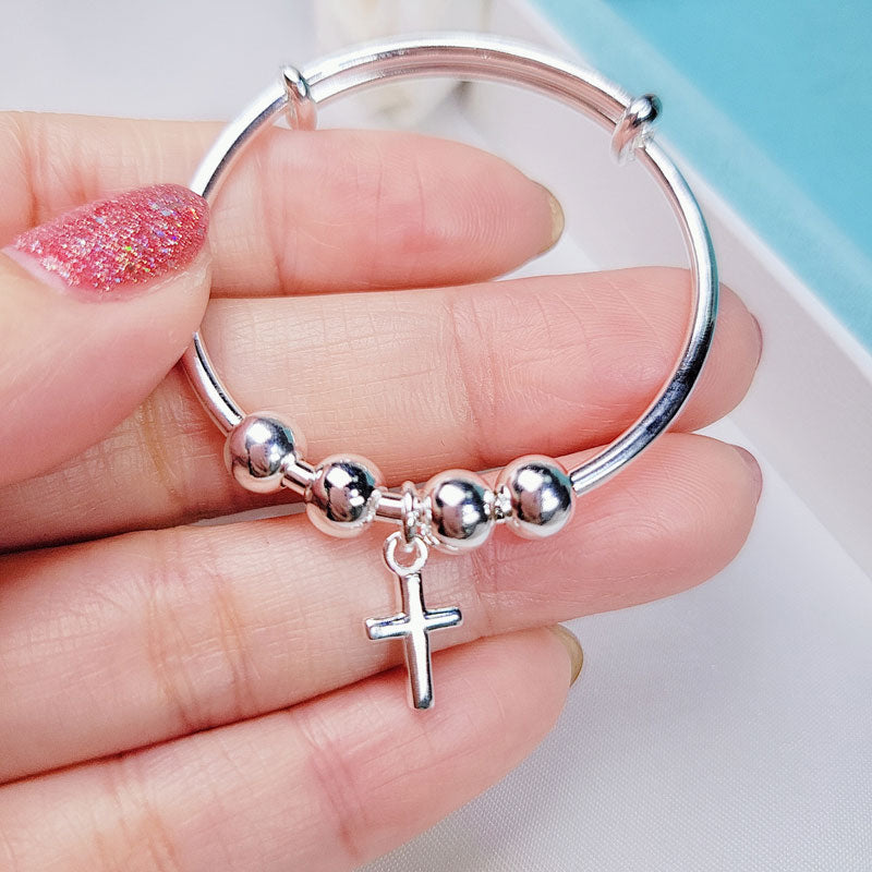 Pulsera ajustable con cruz en plata de ley para niñas