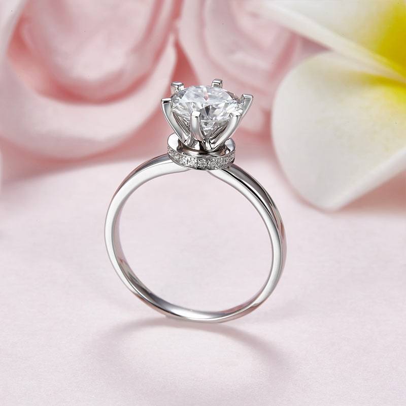 Anillo de compromiso de moissanita redonda de 2 quilates con halo de diamantes en plata de ley.