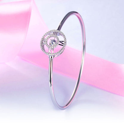 Pulsera brazalete con piedra danzante y reloj con números romanos