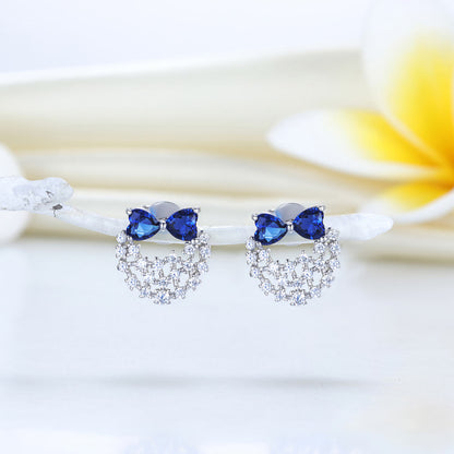 Pendientes de plata de ley con diamantes de imitación azules y lazos de corazón 