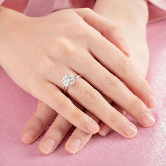 Anillo de compromiso de moissanita redonda de 1,5 quilates con halo de diamantes en plata de ley.