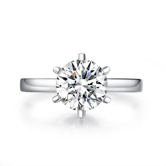 Anillo de compromiso de moissanita redonda de 2 quilates con halo de diamantes en plata de ley.